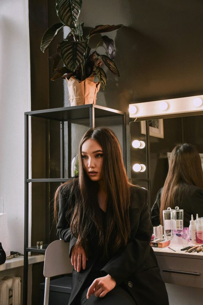 woman in brown leather jacket sitting on chair